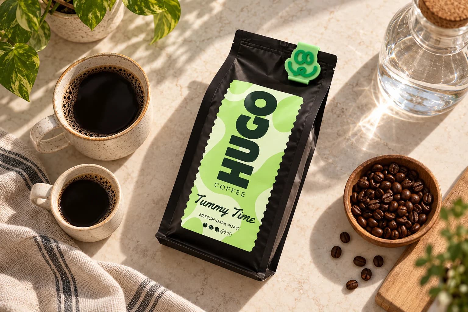 A freshly brewed cup beside a Hugo Coffee bag