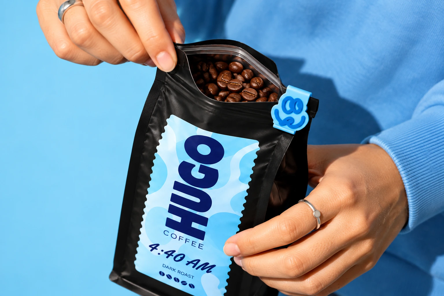 Scooping whole coffee beans from a freshly opened bag of 4:40 AM